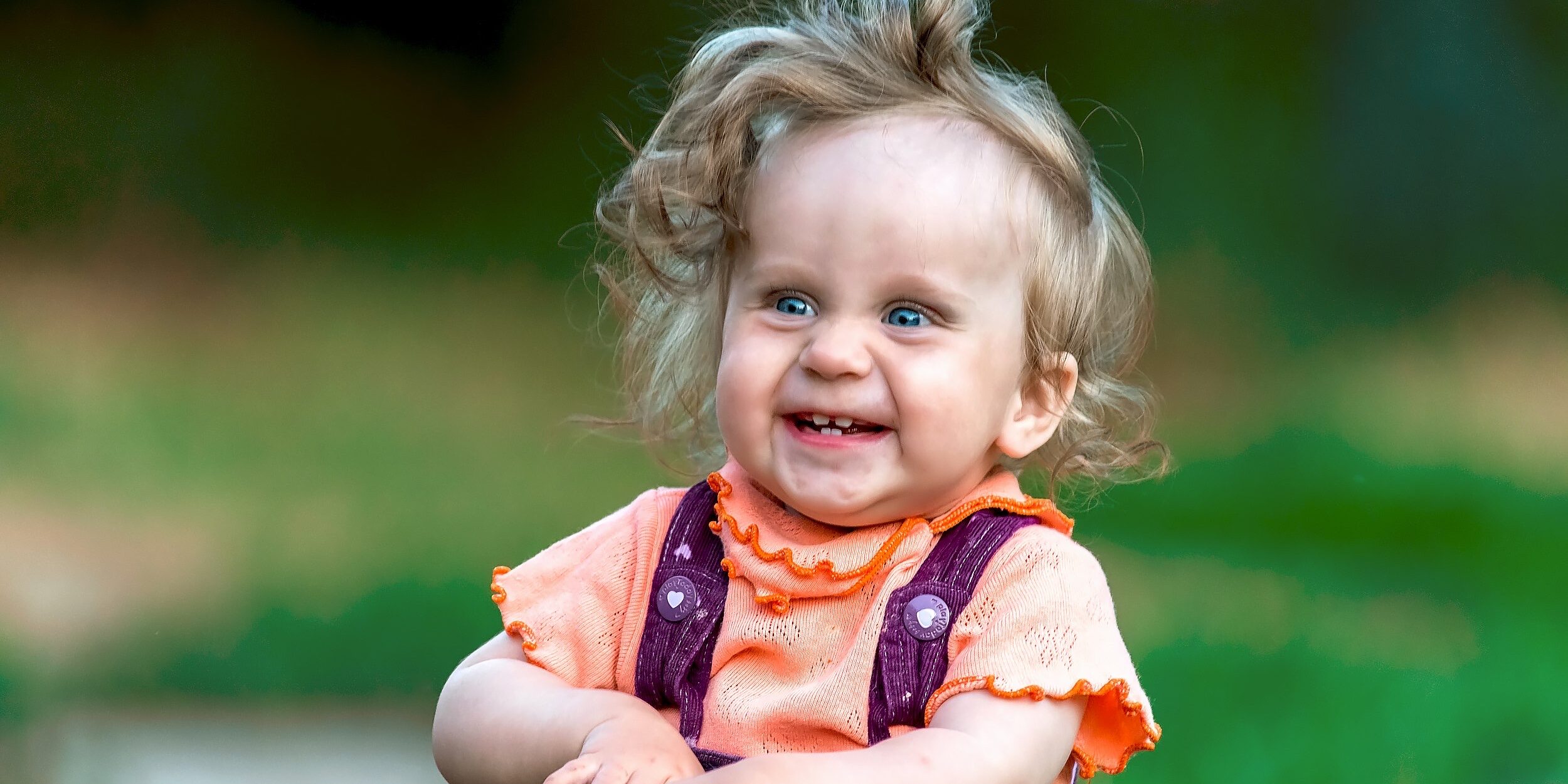 happy infant with early oral development milestones supported by pediatric dental care at Olathe Pediatric Dental in Olathe, KS